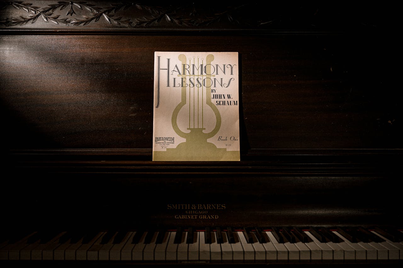 Dark, vintage piano with 'Harmony Lessons' sheet music, offering a classic and artistic ambiance.