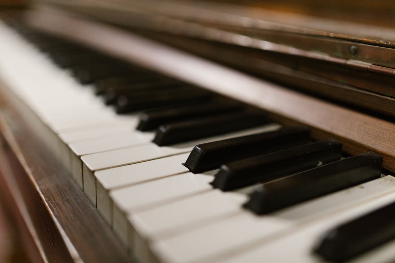 A close-up view of piano keys, showcasing their classic design under warm lighting.